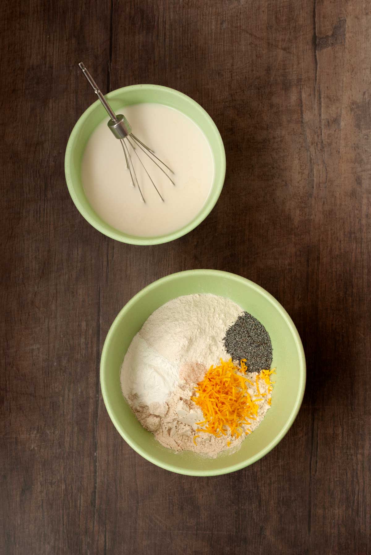 Two bowls, one filled with wet ingredients and one filled with dry ingredients.