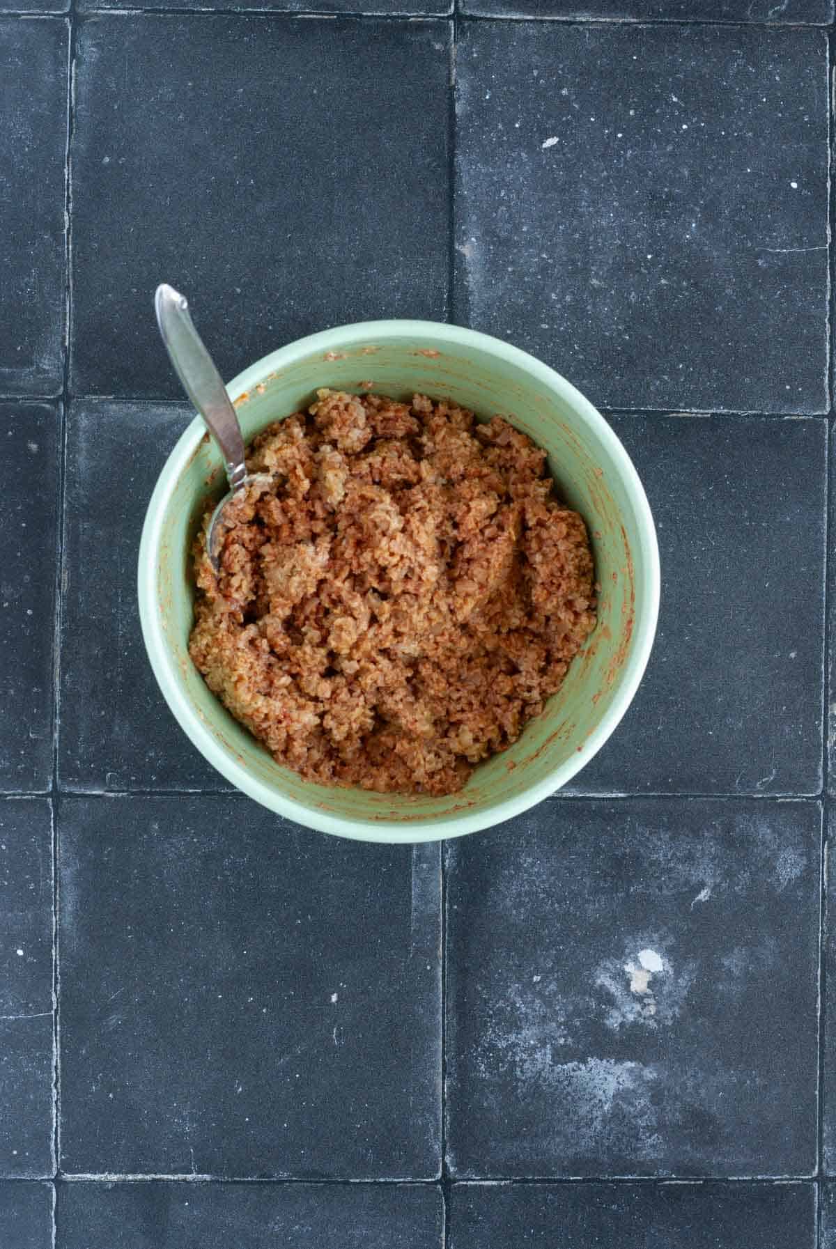 Ingredients for vegan TVP lentil burgers shown mixed together in a bowl.
