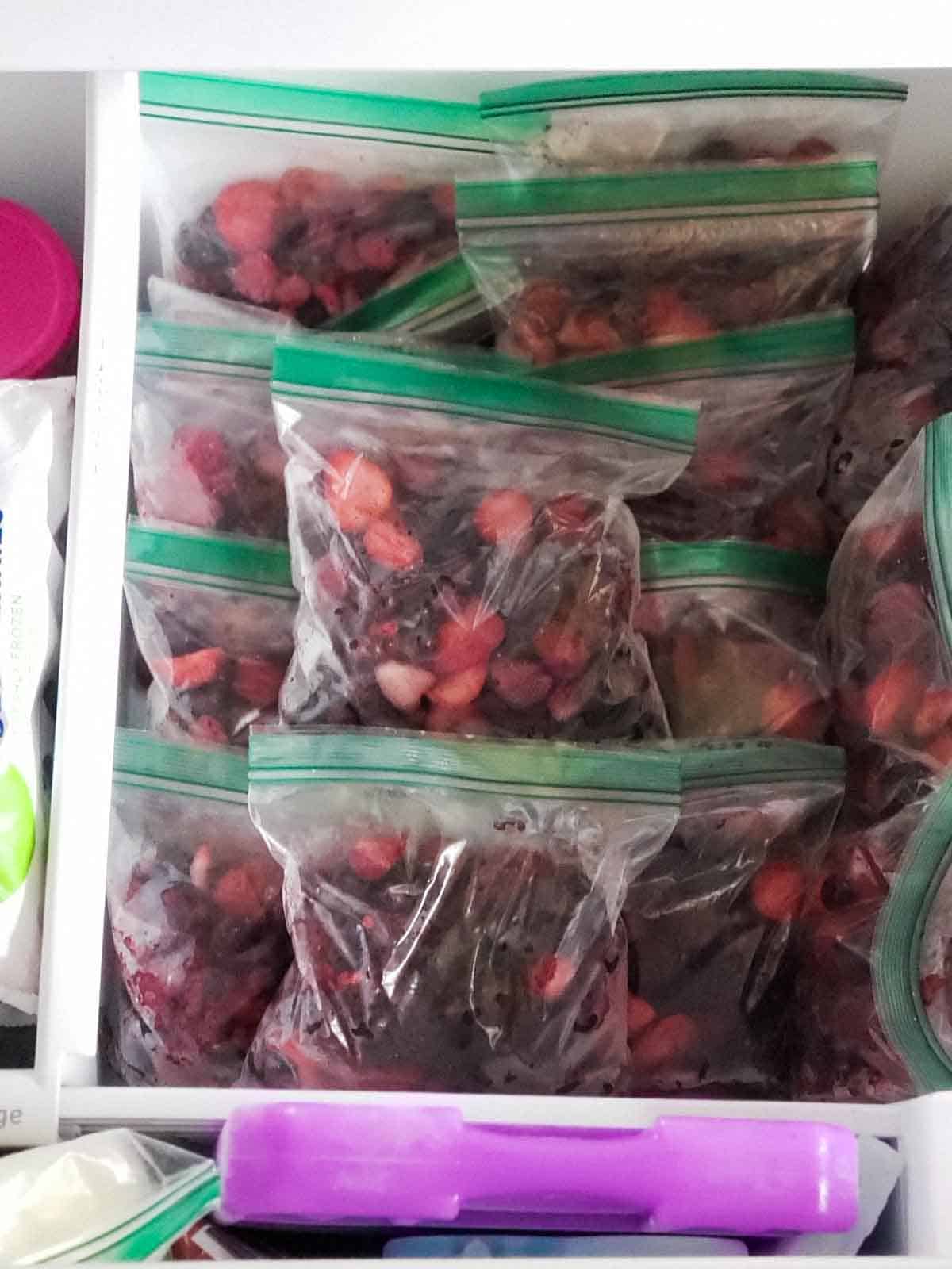 All of the bags of mixed berries stacked up in the freezer.