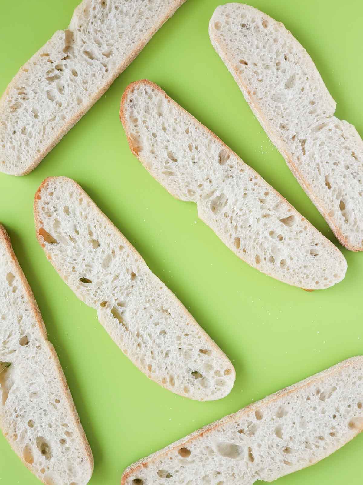 6 Bread slices on a cutting board ready for sandwich making.