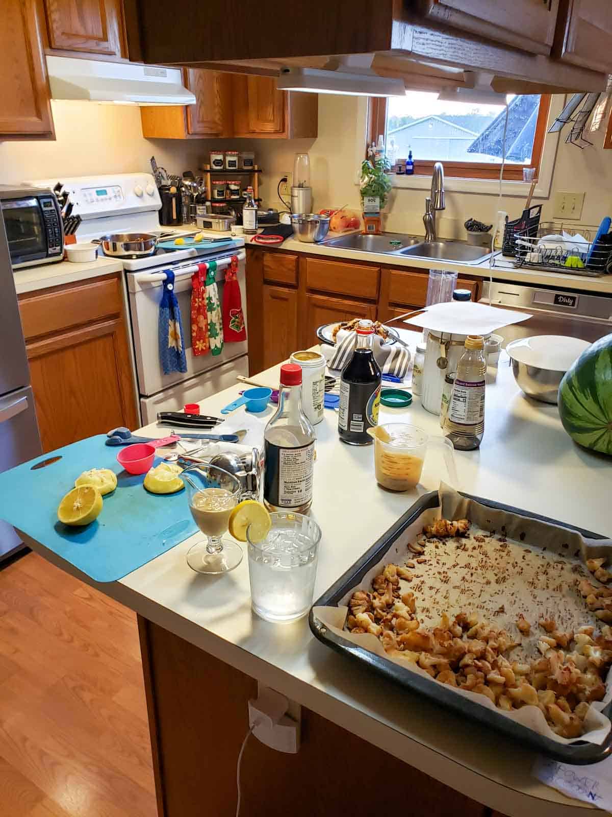 A completely messy kitchen from cooking all day and preparing the roasted cauliflower, vegan sausage, lentil recipe.