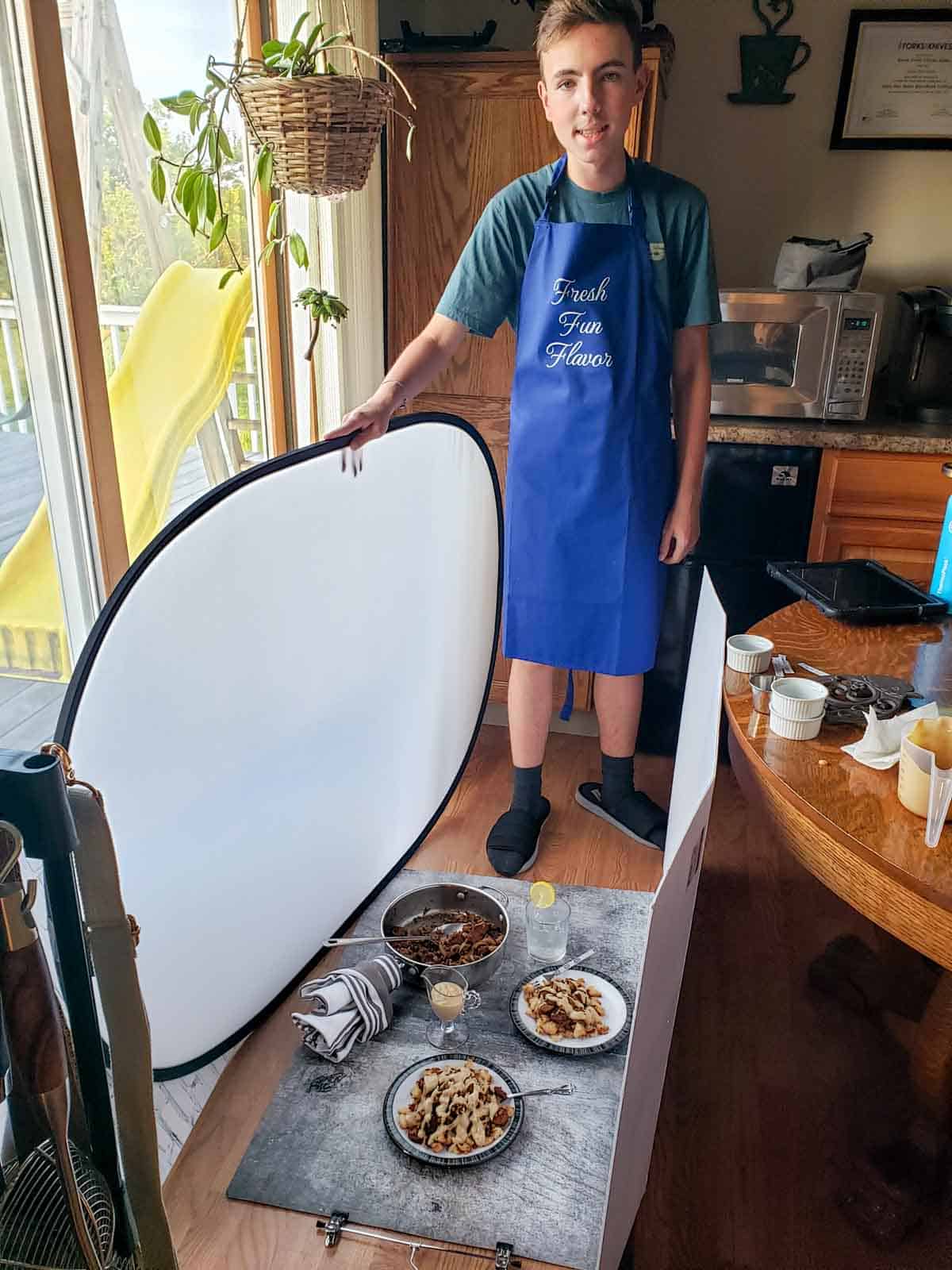 Justin helping out by holding the diffuser while I take the feature photo for the cauliflower sausage lentil recipe.