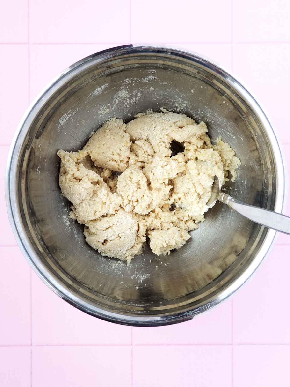 The combined cookie dough in a mixing bowl with a spoon.
