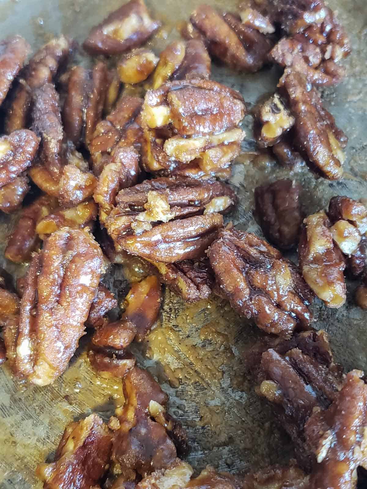 Close up of how to candy pecans using coconut sugar and maple syrup.