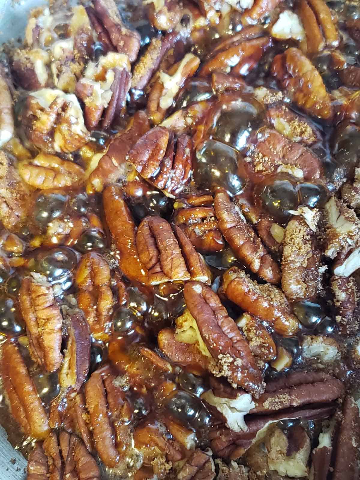 Close up of how to candy pecans using coconut sugar and maple syrup.