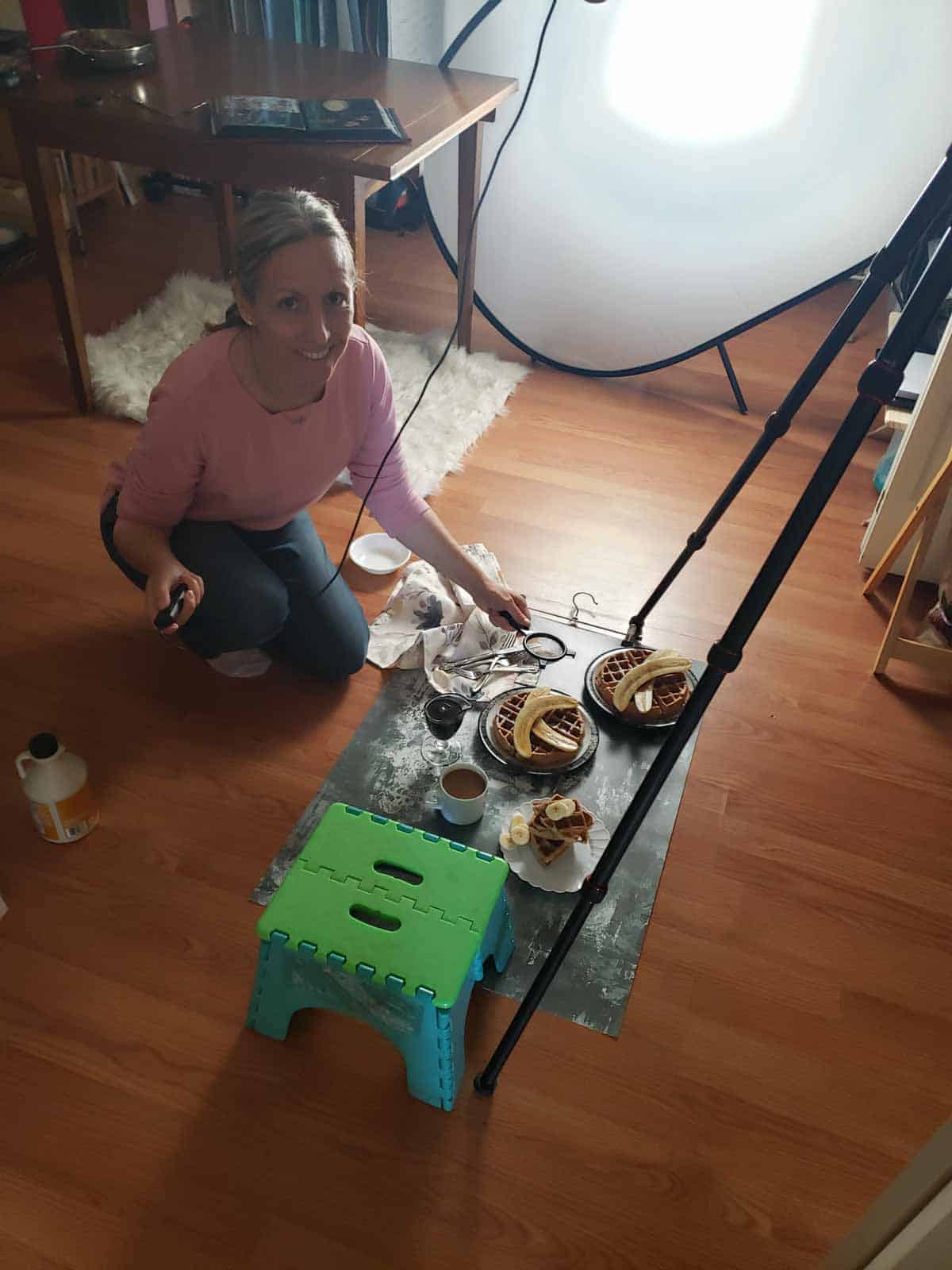 Behind the scenes of food photography with waffles styled on floor set.