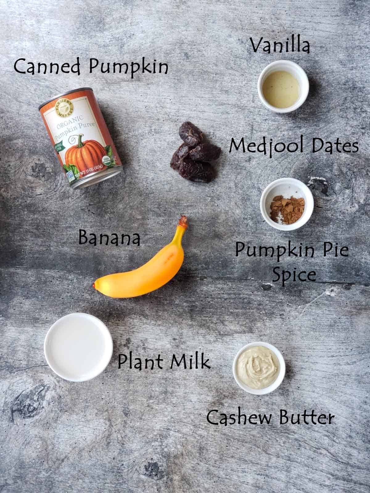 Overhead of ingredients labeled including pumpkin puree, banana, and cashew butter.