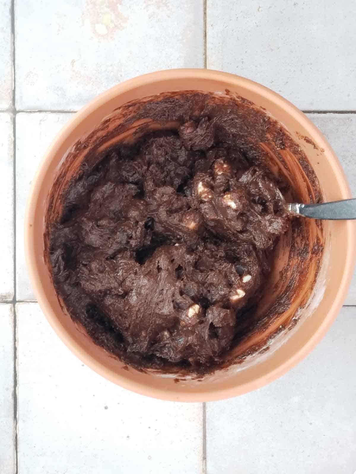 Thick vegan chocolate cookie dough with marshmallows before baking.