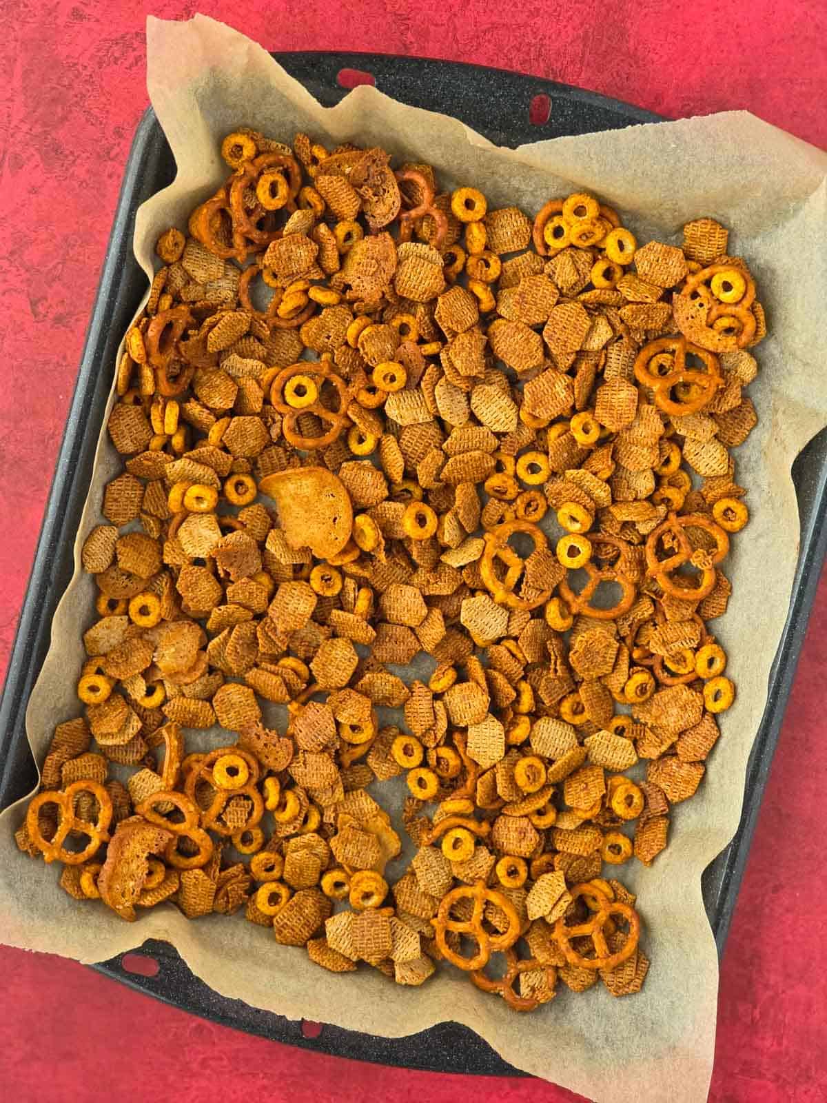 Fully baked Vegan Chex mix cooling on a baking sheet.