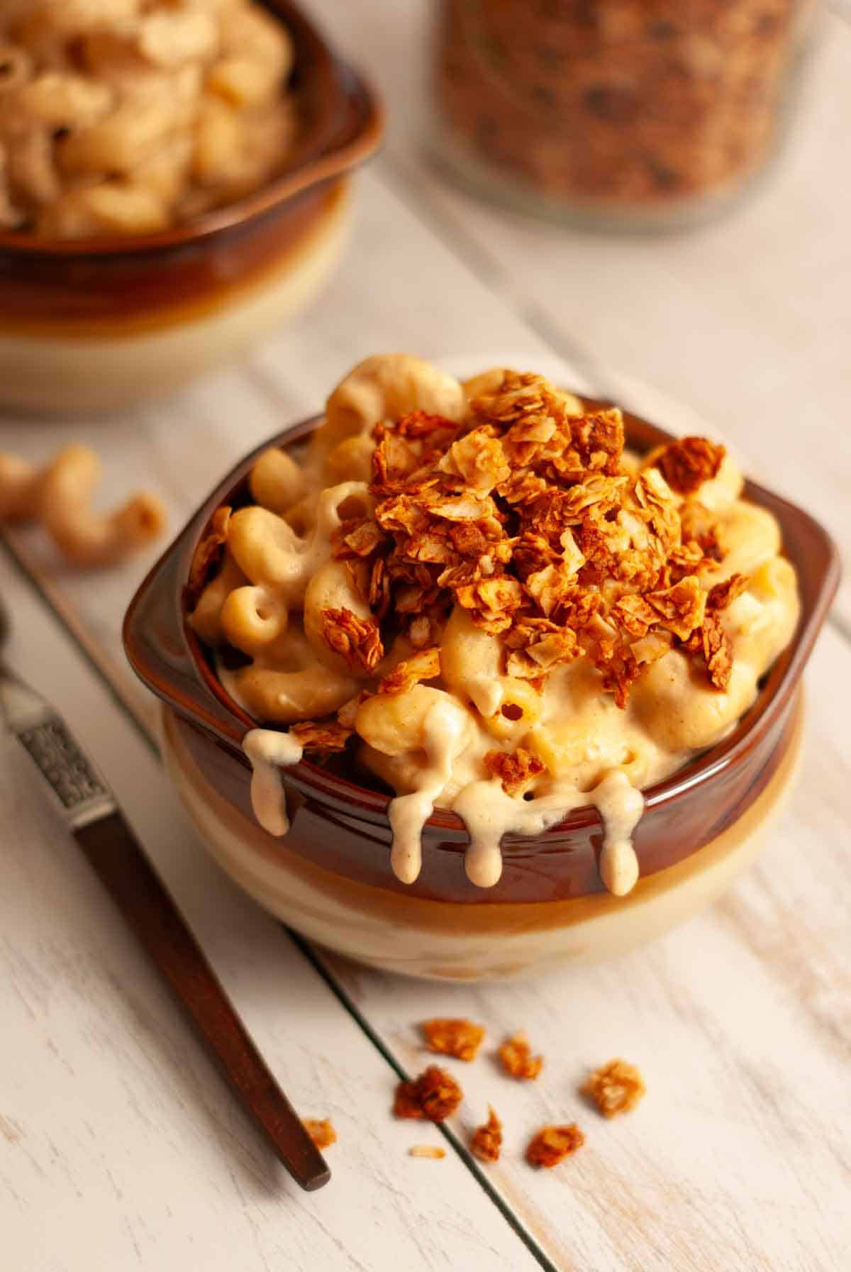 Close-up of coconut bacon bits on a bowl of vegan mac and cheese.