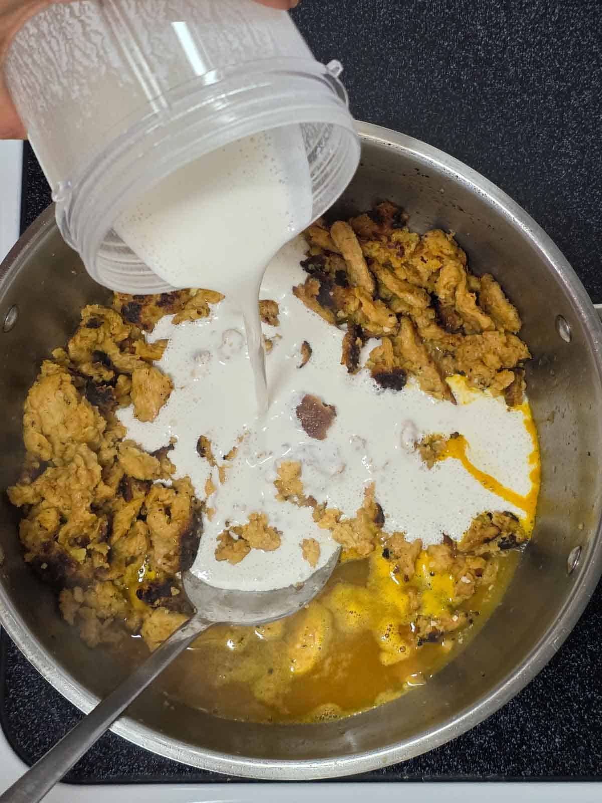 Adding cashew cream to the skillet to create the silky base for the vegan piccata mixture.