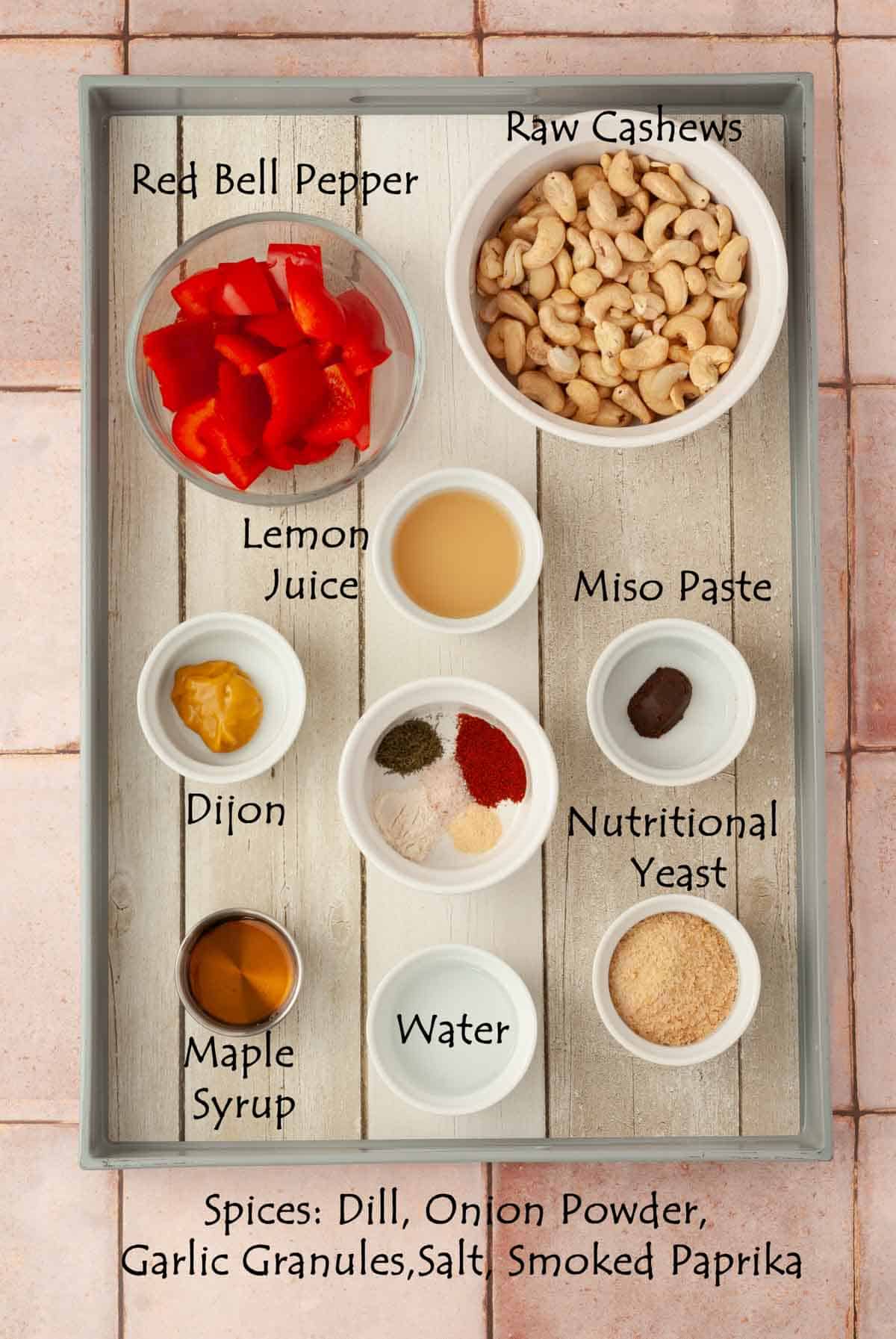 Ingredient flat lay for the creamy vegan veggie dip with red bell pepper, maple syrup, dijon and spices.