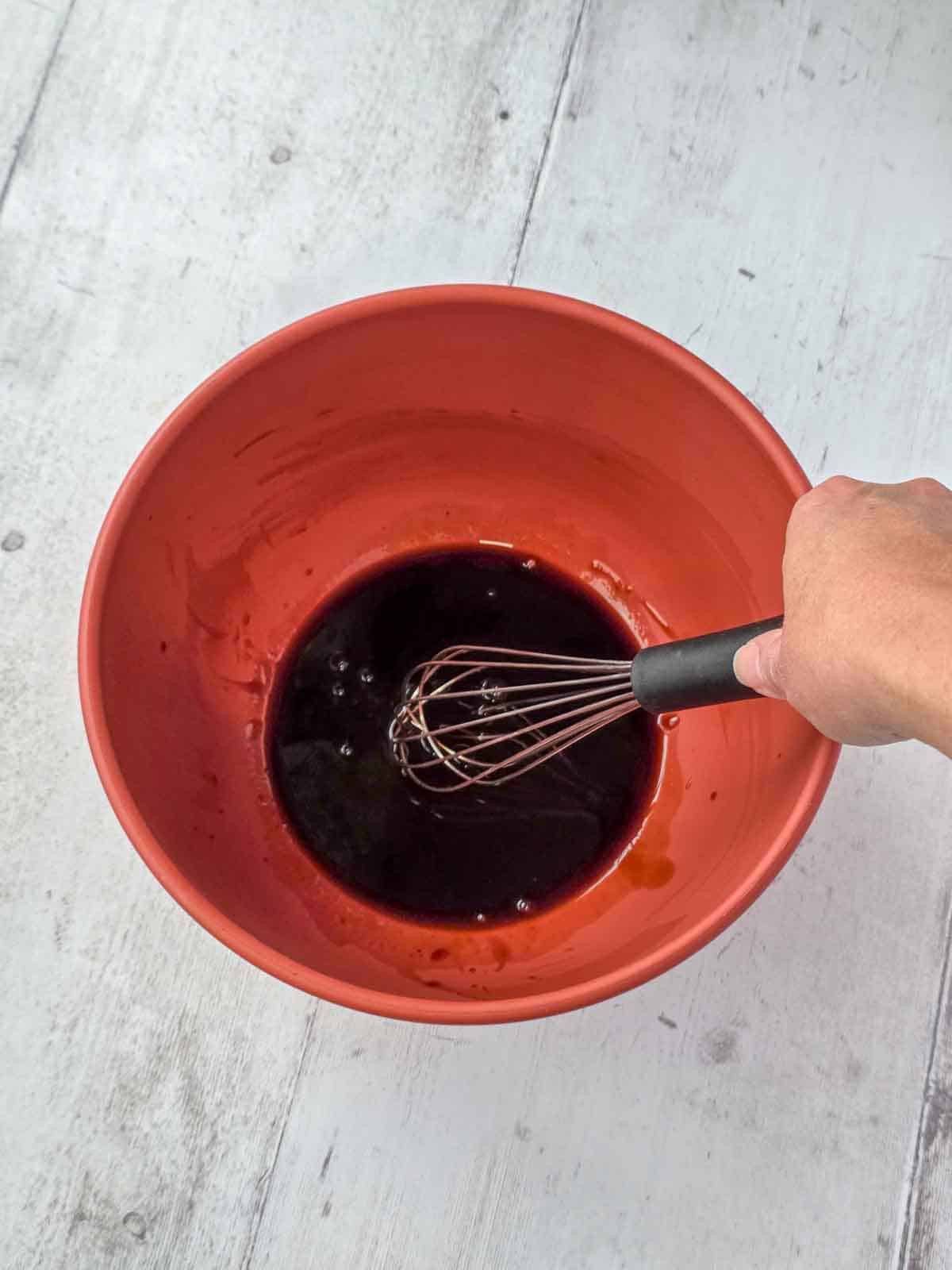 BBQ sauce and soy sauce whisked together in a bowl.