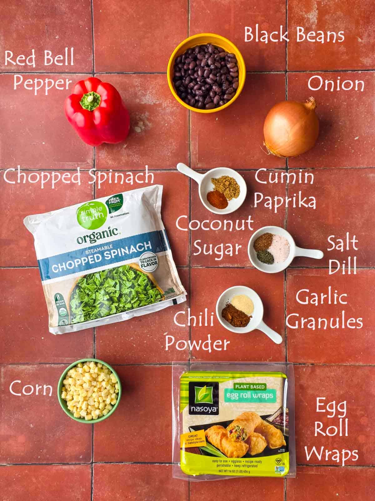 Labeled ingredients for southwest egg rolls including black beans, spinach, corn, spices, and egg roll wrappers.