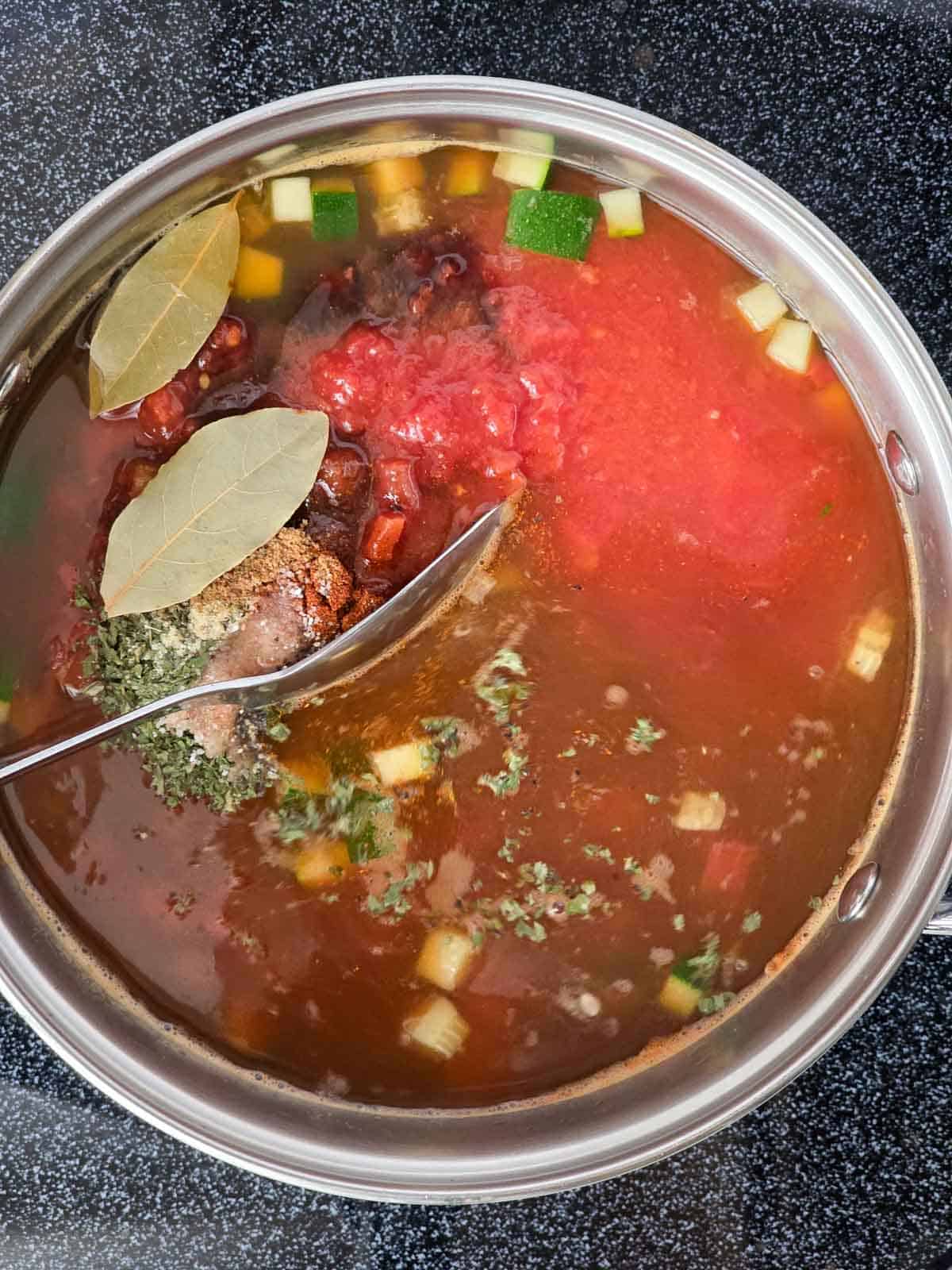 Bay leaves added to the vegetable soup before simmering.