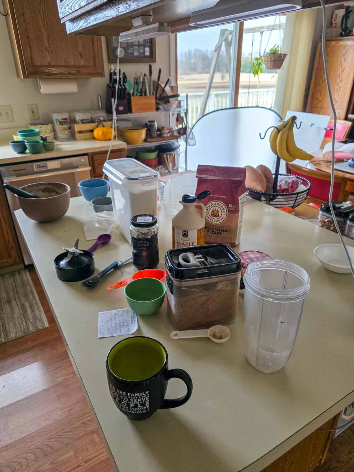 Ingredients and tools set up on a kitchen counter for making pancakes.