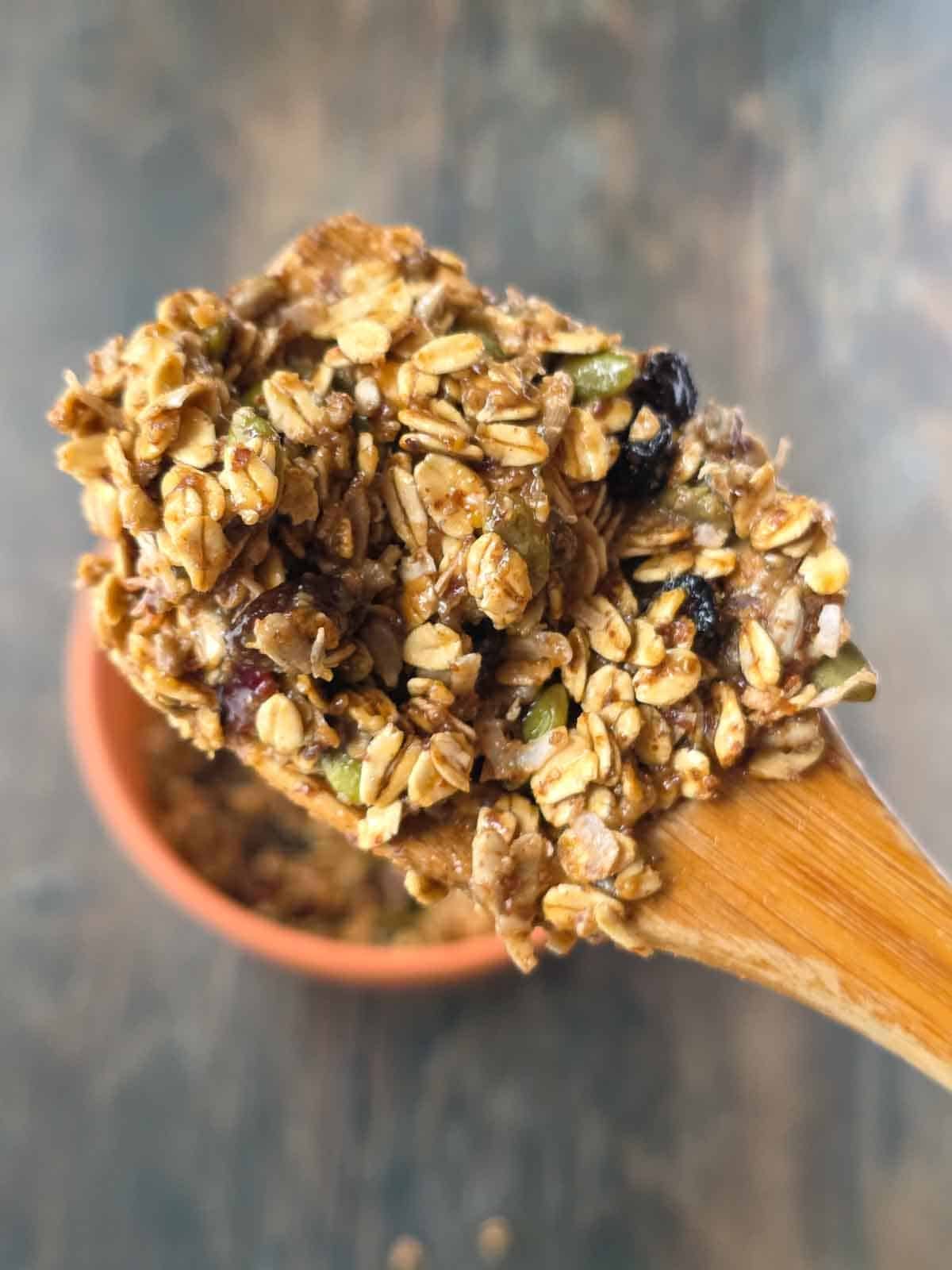 Close-up of the sticky granola bar mixture with oats, seeds and dried berries.