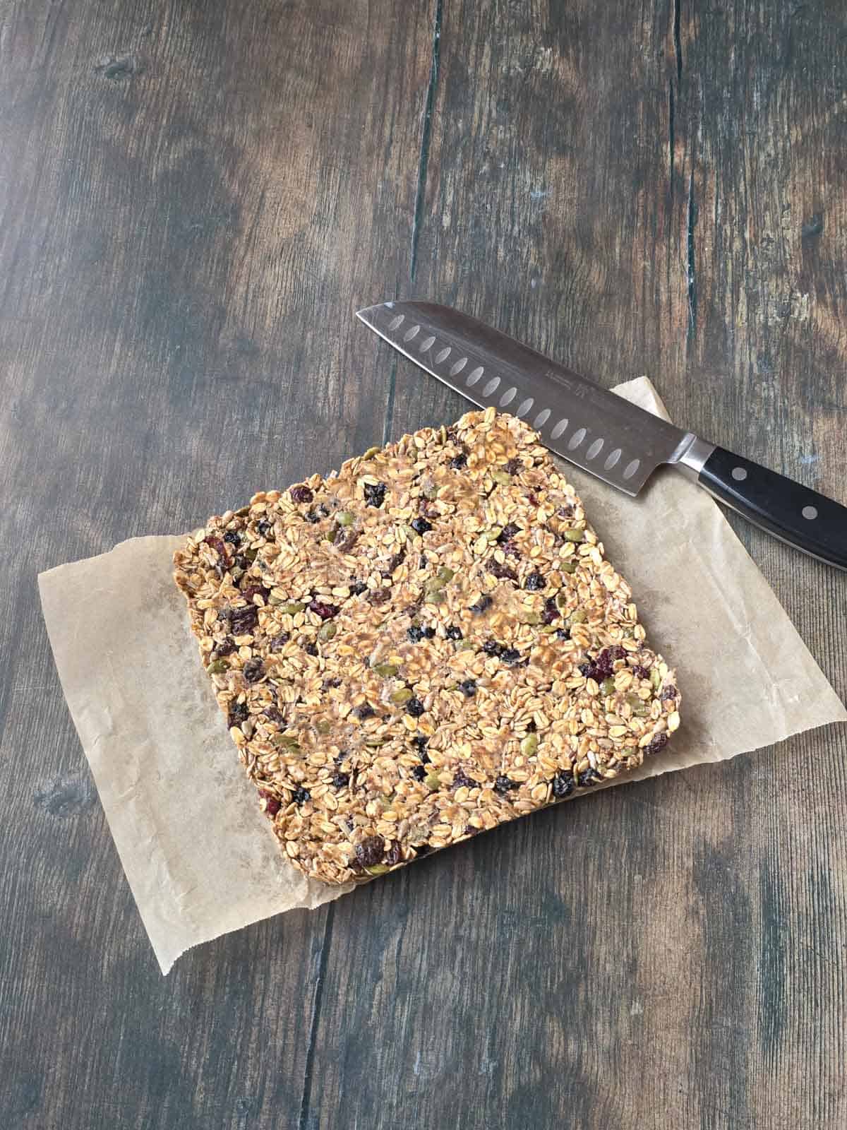Firmly packed granola bar mixture removed from the pan and ready for cutting.